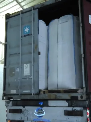 Industrial loading of corn cob into bulk Big Bags for efficient shipment.