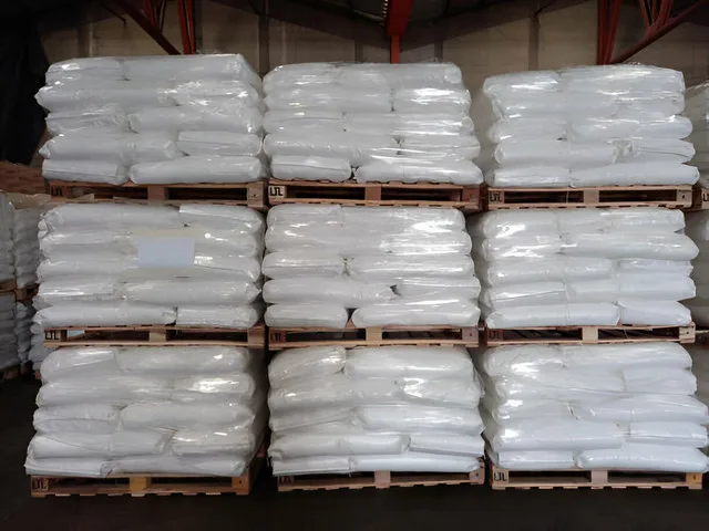 Pallets stacked with white bags
